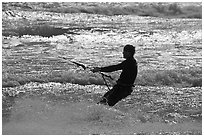 Kitesurfer silhouette against silvery water, Waddell Creek Beach. California, USA ( black and white)
