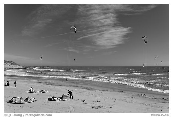 Kitesurfers rolling out sails on on beach, Waddell Creek Beach. California, USA (black and white)