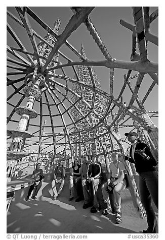 Tour guide and group in the Gazebo of the Watts Towers. Watts, Los Angeles, California, USA (black and white)