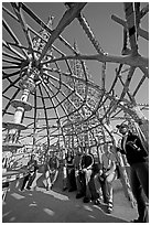 Tour guide and group in the Gazebo of the Watts Towers. Watts, Los Angeles, California, USA (black and white)