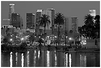 Skyline and lights reflected in a lake in Mc Arthur Park. Los Angeles, California, USA (black and white)