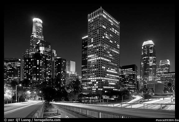 Bridge, traffic lights and Los Angeles skyline at night. Los Angeles, California, USA
