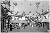 Lanterns and pedestrian street in rainy weather,  Chinatown. Los Angeles, California, USA ( black and white)
