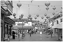 Lanterns and pedestrian street in rainy weather,  Chinatown. Los Angeles, California, USA (black and white)