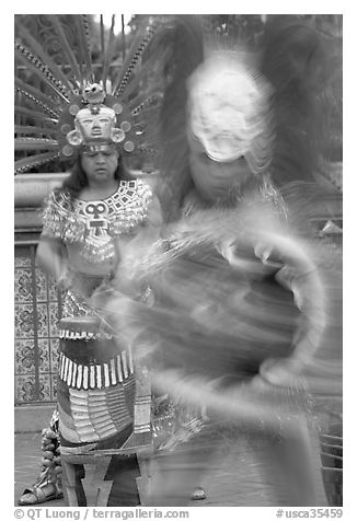 Aztec dancers in motion,  El Pueblo historic district. Los Angeles, California, USA (black and white)
