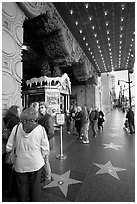 Stars of the Walk of fame in front of the  El Capitan Theatre. Hollywood, Los Angeles, California, USA (black and white)