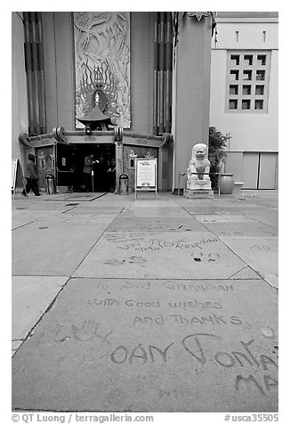 Handprints and footprints of actors and actresses in cement, Grauman theater forecourt. Hollywood, Los Angeles, California, USA (black and white)