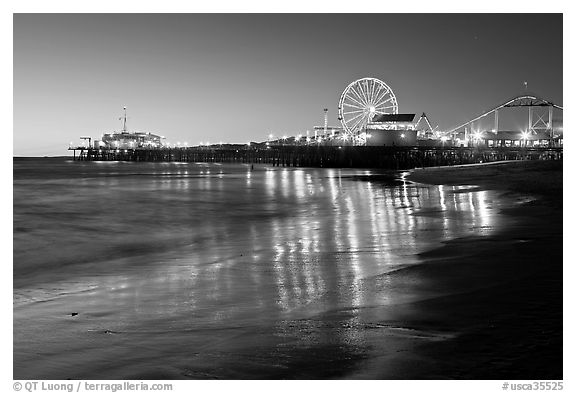 Pier and Ferris Wheel reflected on beach at dusk. Santa Monica, Los Angeles, California, USA