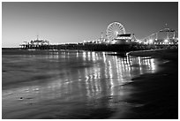 Pier and Ferris Wheel reflected on beach at dusk. Santa Monica, Los Angeles, California, USA ( black and white)