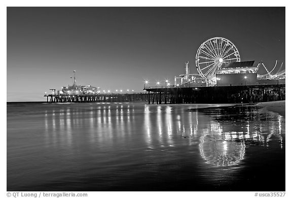 Pier, Ferris Wheel, and reflections  at dusk. Santa Monica, Los Angeles, California, USA (black and white)