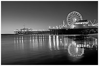 Pier, Ferris Wheel, and reflections  at dusk. Santa Monica, Los Angeles, California, USA ( black and white)