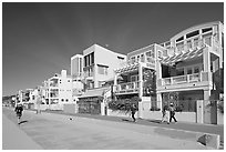 People jogging and strolling on beach promenade. Santa Monica, Los Angeles, California, USA ( black and white)