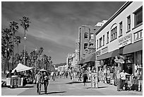 Couple strolling on Venice Boardwalk. Venice, Los Angeles, California, USA (black and white)