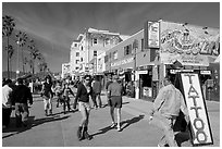 Rollerblading on colorful Ocean Front Walk. Venice, Los Angeles, California, USA (black and white)