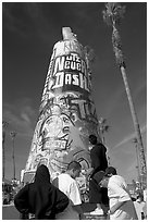 Young men decorating a cone on the beach. Venice, Los Angeles, California, USA (black and white)