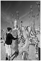 Young man making graffiti on a wall. Venice, Los Angeles, California, USA (black and white)