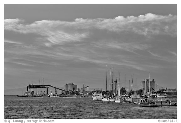 Yachts and industrial installations, port of Redwood, sunset. Redwood City,  California, USA (black and white)