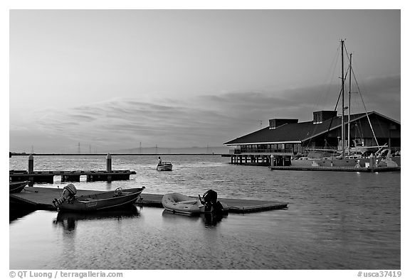 Marina, with small boat comming back to port at sunset. Redwood City,  California, USA (black and white)