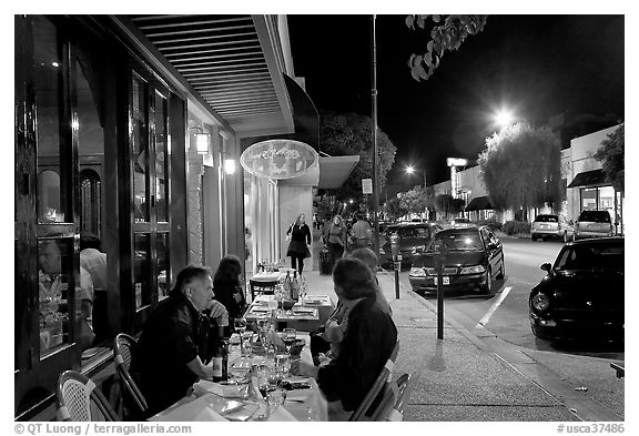 Sidewalk with Outdoor restaurant table and people walking. Burlingame,  California, USA (black and white)