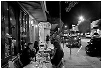 Sidewalk with Outdoor restaurant table and people walking. Burlingame,  California, USA (black and white)