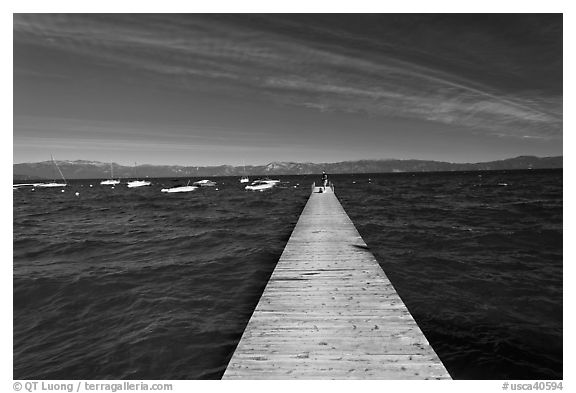 Dock, small boats, and blue waters and mountains, Lake Tahoe, California. USA