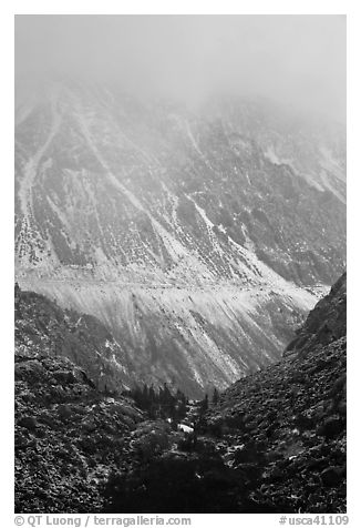 Mountains cut by Tioga Pass road with fresh snow. California, USA (black and white)