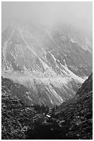 Mountains cut by Tioga Pass road with fresh snow. California, USA ( black and white)