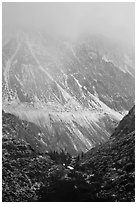 Mountains cut by Tioga Pass road with fresh snow. California, USA (black and white)