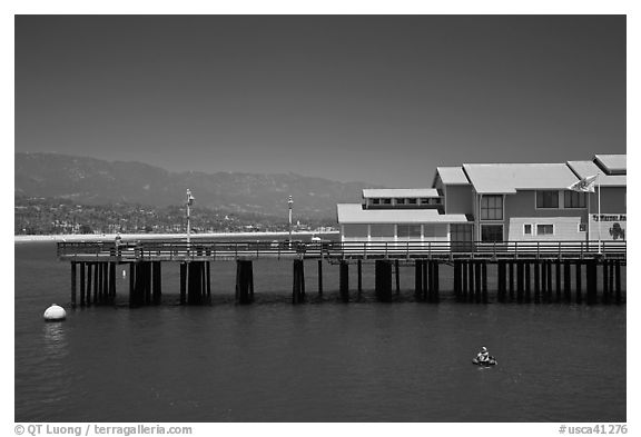 Man on buoy and pier. Santa Barbara, California, USA