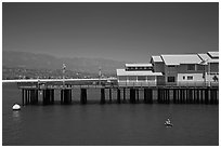 Man on buoy and pier. Santa Barbara, California, USA ( black and white)