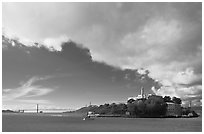 Golden Gate Bridge and Alcatraz under large cloud. San Francisco, California, USA (black and white)