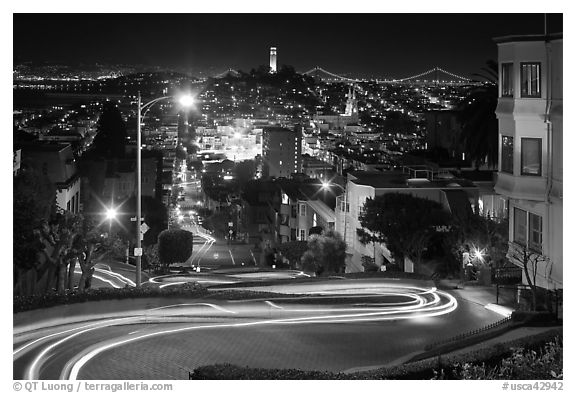 Sharp switchbacks on Russian Hill with Telegraph Hill in the background, night. San Francisco, California, USA