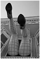 Legs with fishnet stockings hanging from a window, Haight-Ashbury District. San Francisco, California, USA (black and white)