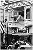 Woman exiting car below women legs with stockings. San Francisco, California, USA ( black and white)