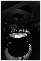 Tourists look at moving image of ocean inside the Camera Obscura, Cliff House. San Francisco, California, USA (black and white)