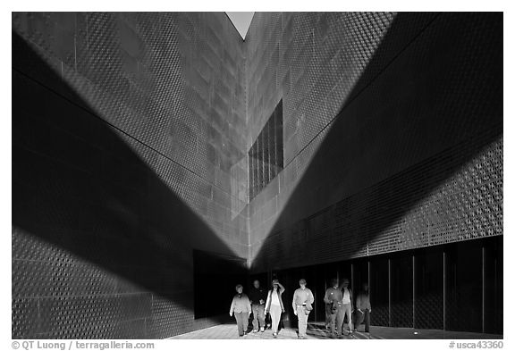 Tourists walking out of a striking corner of De Young Museum. San Francisco, California, USA