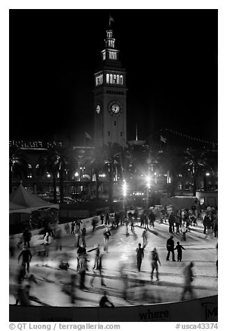 Ice rink and Ferry Building tower at night. San Francisco, California, USA (black and white)