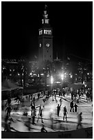 Ice rink and Ferry Building tower at night. San Francisco, California, USA (black and white)