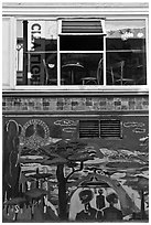Decor from beatnik period and window reflecting city light sign, North Beach. San Francisco, California, USA (black and white)