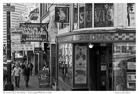 Sidewalk with Vesuvio Cafe, Jack Kerouac street sign, Columbus Tower, and Transamerica Pyramid, North Beach. San Francisco, California, USA (black and white)