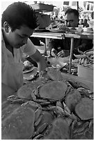 Man preparing crabs, Fishermans wharf. San Francisco, California, USA ( black and white)