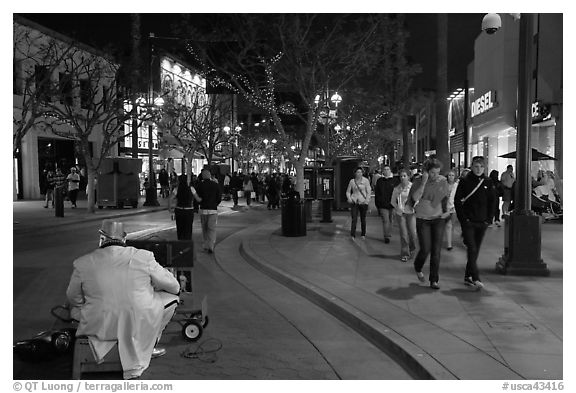 People walking past mime on Third Street Promenade. Santa Monica, Los Angeles, California, USA