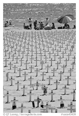 War memorial and families at edge of water on beach. Santa Monica, Los Angeles, California, USA