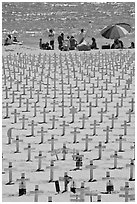 War memorial and families at edge of water on beach. Santa Monica, Los Angeles, California, USA (black and white)