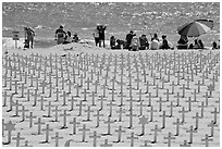 Wooden crosses, stars of David, and beachgoers. Santa Monica, Los Angeles, California, USA ( black and white)