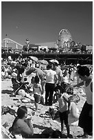 Families on beach and Pacific Park on Santa Monica Pier. Santa Monica, Los Angeles, California, USA (black and white)