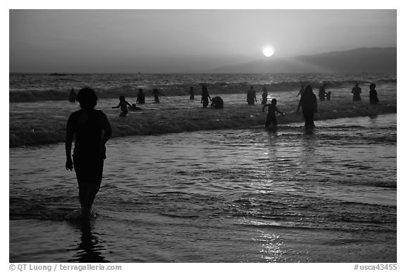 Ocean bathers at sunset, Santa Monica Beach. Santa Monica, Los Angeles, California, USA (black and white)