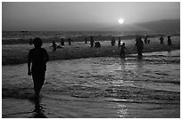 Ocean bathers at sunset, Santa Monica Beach. Santa Monica, Los Angeles, California, USA ( black and white)