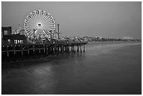 Ferris Wheel and beach at dusk, Santa Monica Pier. Santa Monica, Los Angeles, California, USA (black and white)