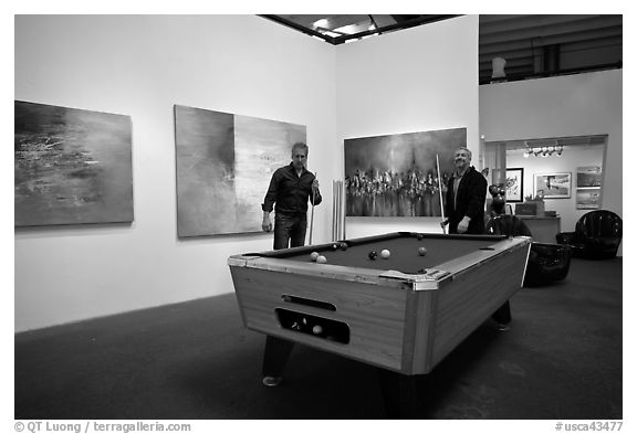 Playing pool inside a contemporary art gallery, Bergamot Station. Santa Monica, Los Angeles, California, USA (black and white)